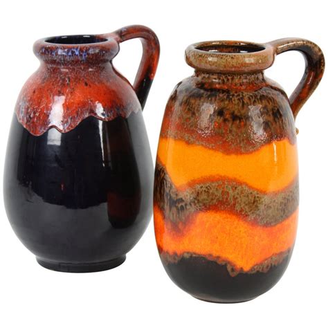 duo of fat lava west germany pottery vases in vibrant orange and dark