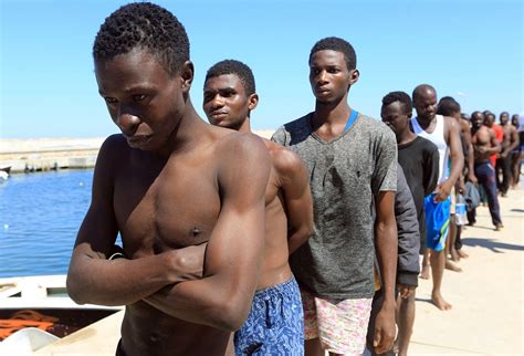 starved mutilated and blackmailed migrants auctioned off as slaves by smugglers in libya