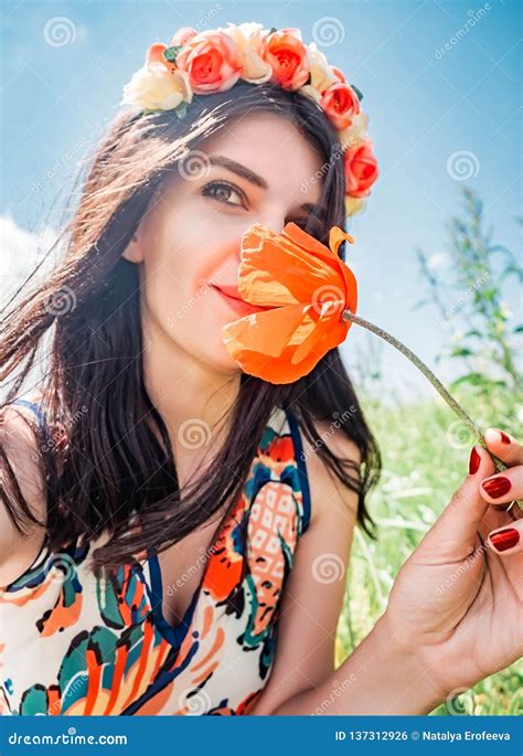Young Beautiful Happy Woman In Flower Wreath Inhales The Aroma Of A