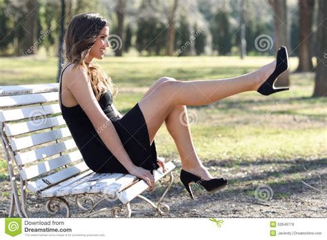 Funny Female Model Of Fashion With High Heels Sitting On A
