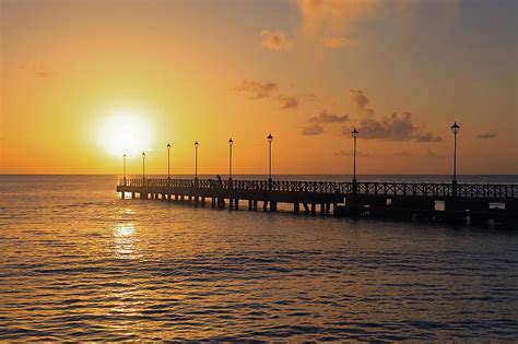 sunset pier in barbados photograph by andrea urlass fine art america