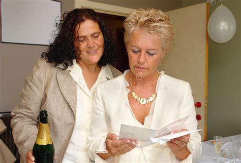 lesbian couple reading greeting card stock image image