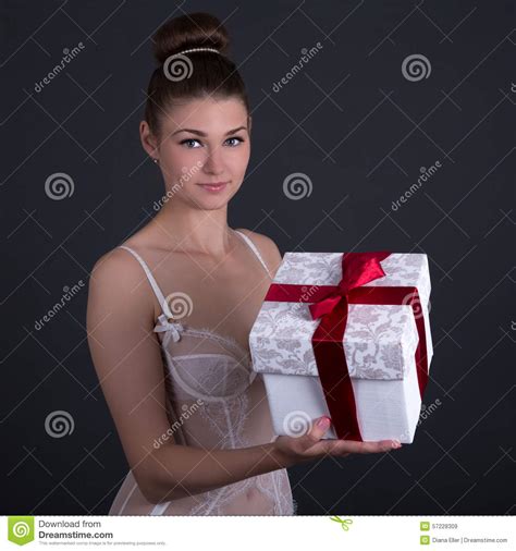 beautiful woman in white lingerie with t box over grey stock image