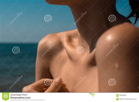 beautiful female shoulder without bikini on tropical beach