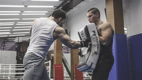 huge strong bodybuilder boxing and wrestling weaker muscle