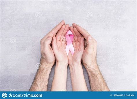 Healthcare And Medicine Concept Female And Male Hands Hold Pink