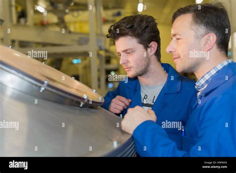 happy mechanics checking machine result stock photo alamy