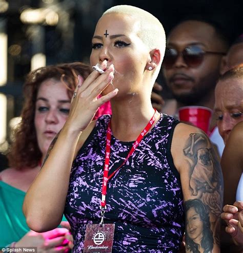Amber Rose Sports An Inverted Cross Design On Her Forehead