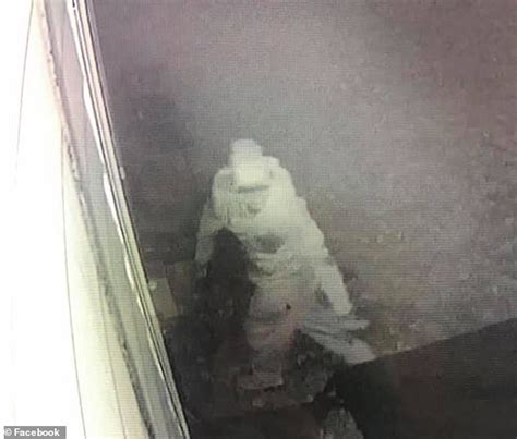 ski mask wearing peeping tom is caught on camera staring into woman s