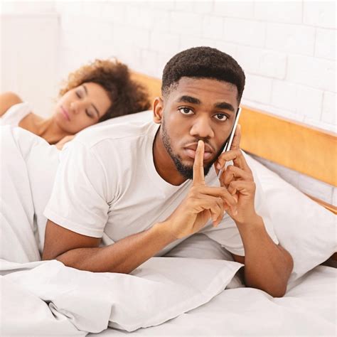 Premium Photo Cheating African Husband Talking Privately On Cellphone