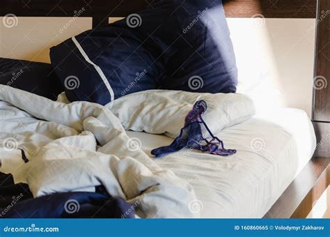 Women`s Lace Blue Panties On A Crumpled Bed Morning After A Hot Night