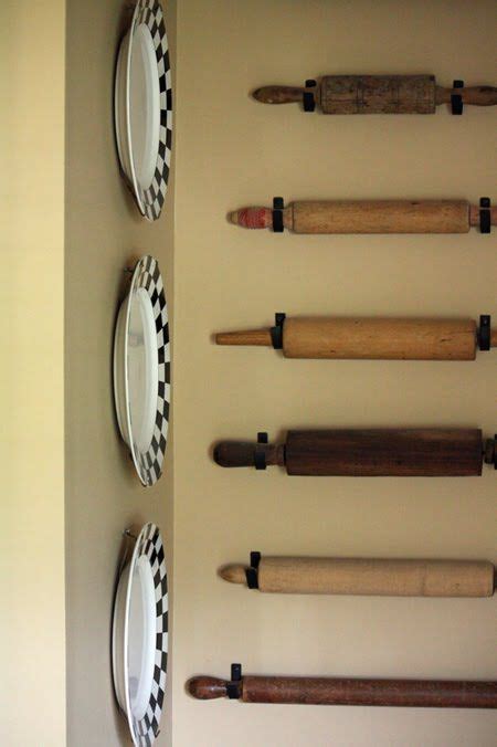 rolling pins hanging from hooks on wall rolling pin