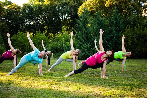 group  women attending  yoga class outdoors clean path behavioral health