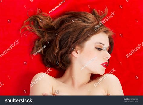 Стоковая фотография 162390782 Attractive Young Naked Woman Lying On