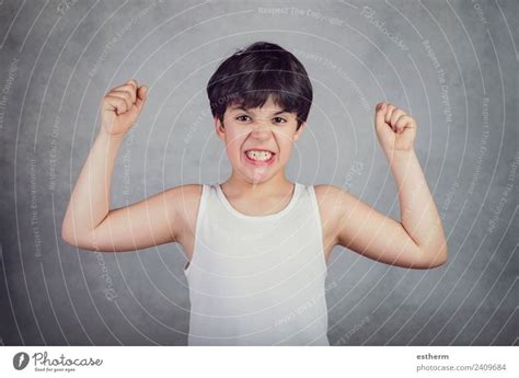 kid showing  muscles  royalty  stock photo  photocase
