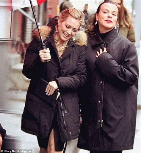 hilary duff covers her chic leather outfit for warm grey sweats in chilly new york shooting tv