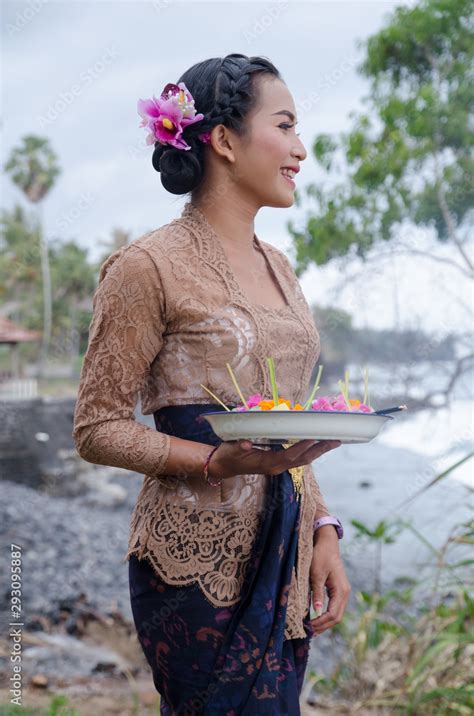 Local Balinese Girl In Their Beautiful Traditional Clothing At Seaside