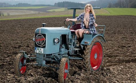 naked farm babes get down to their wellies as they pose by tractors for a bizarre german calendar