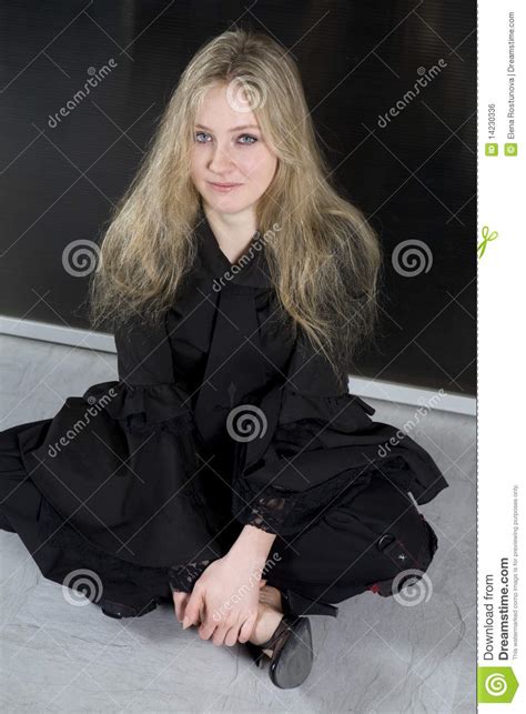 blond teen girl with long hair sitting on floor stock