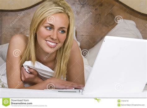 beautiful woman in bed using a laptop computer royalty free stock images image 11316779