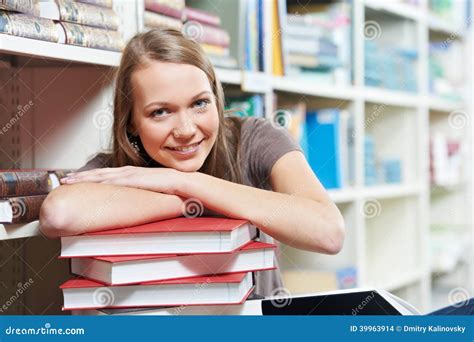 smiling young adult woman reading book  library stock photo image