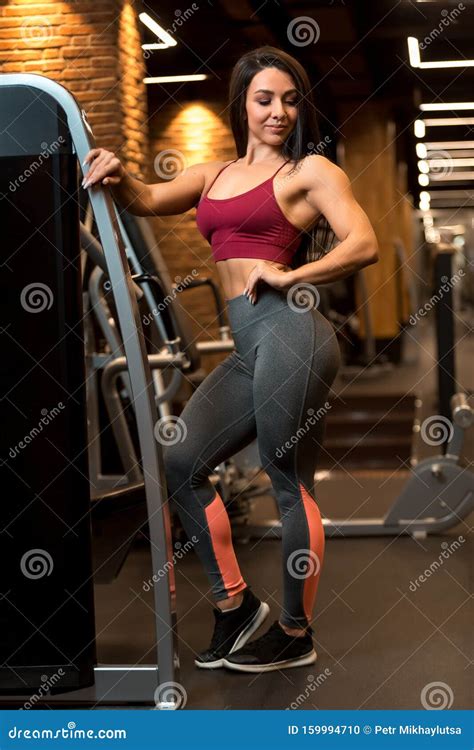 Fitness Brunette Girl Is Standing Near Training Apparatus And Posing