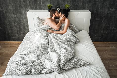 couple in love kissing in bed ~ people photos ~ creative market