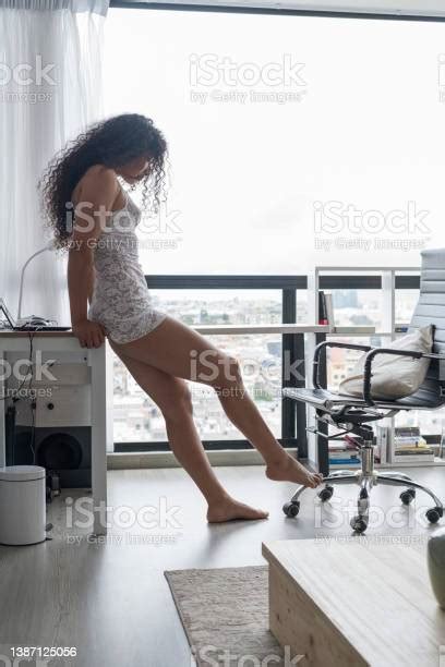 Brunette Latina Woman Is In Pajamas Lying On Her Pc Desk In Her Pajamas