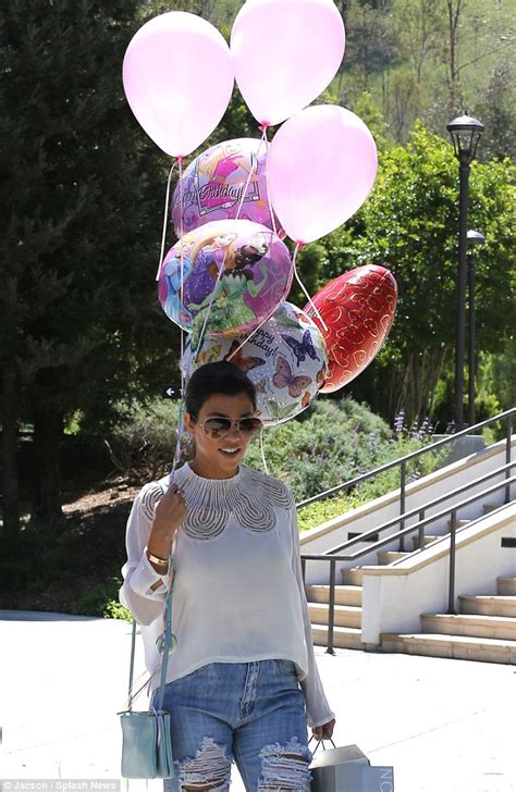 kourtney kardashian gets carried away by a huge balloon bouquet as her