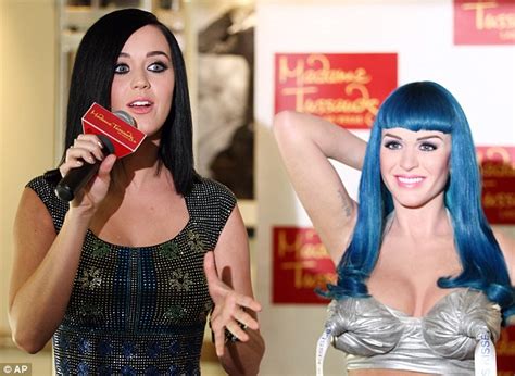 singer strikes a pose with her own wax figure at madame