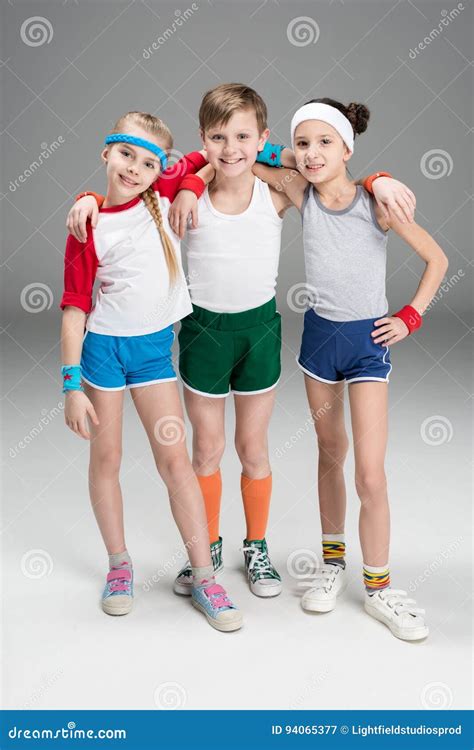 adorable smiling sporty kids  sportswear standing   grey stock image image