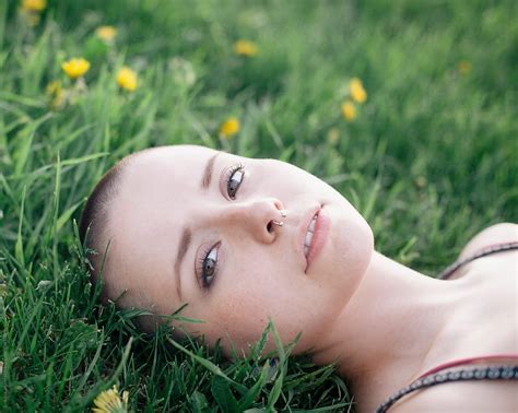 girl lying the grass yellow flowers del colaborador de stocksy erik