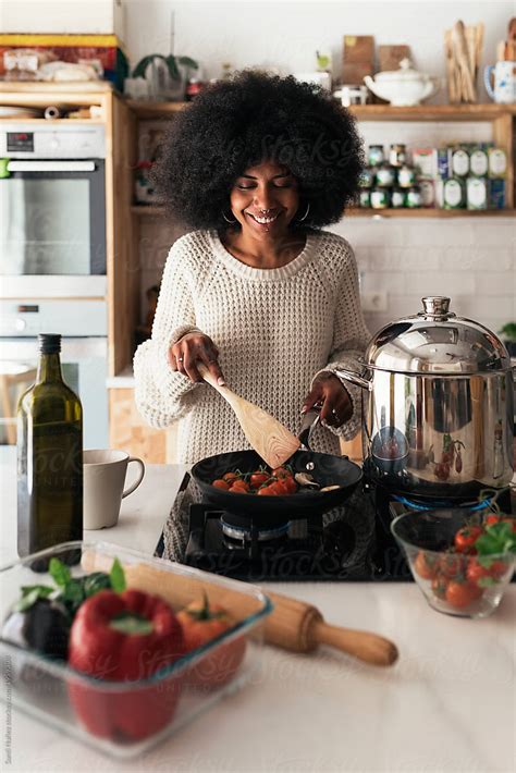 Beautiful Black Woman Cooking In Her Home By Santi Nuñez
