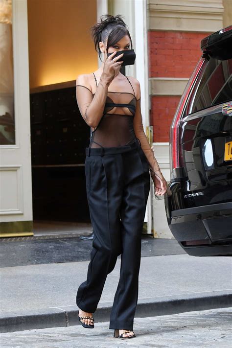 bella hadid looks stunning in a sheer black top with matching trousers
