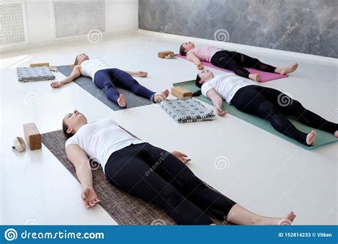 women practicing yoga lesson  dead body savasana exercise