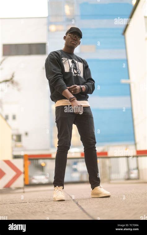 man wearing urban men´s fashion street style clothes at industrial