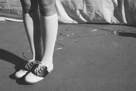 black and white photo of saddle shoes and knee high socks by carolyn