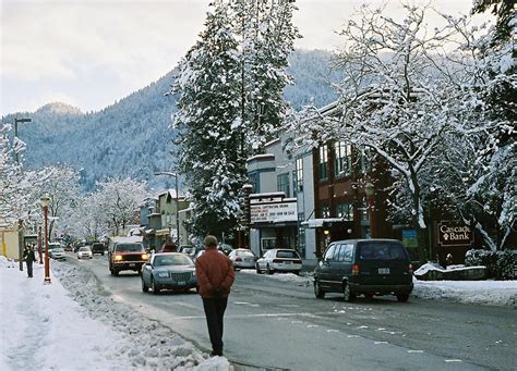man walking   street  front  cars   snowy day