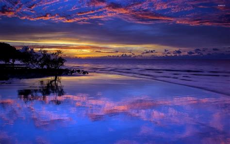amazing purple sunset clouds reflected   wet beach wallpaper