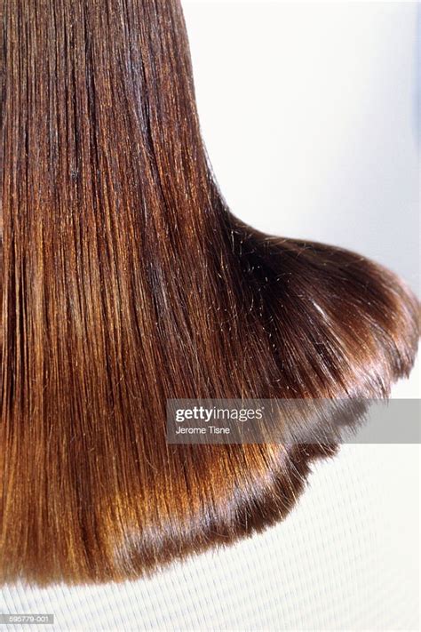 woman with long brown hair falling across shoulderback viewcloseup