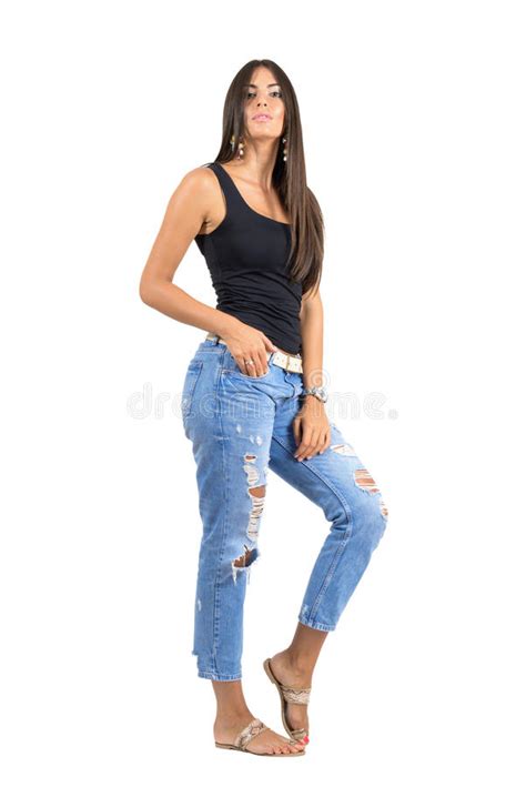Young Casual Woman In Torn Jeans Posing At Camera Full Body Length