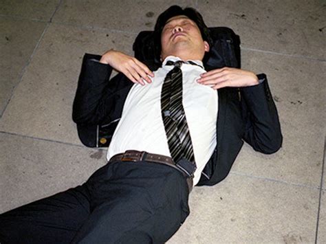 japanese businessmen sleeping on streets capture a culture of overwork
