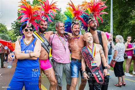 photo libre de droit de men with colorful headpiece at pride walk