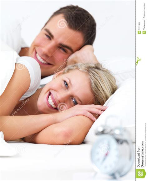happy couple lying in bed together stock image image of