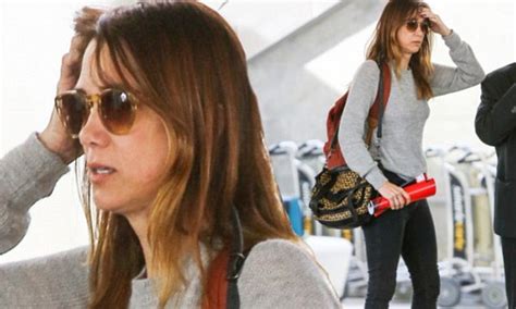 a make up free kristen wiig looks tired yet chic as she