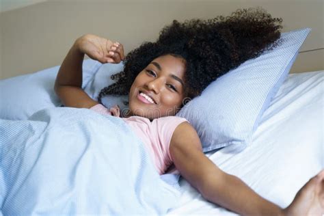 Portrait Of Beautiful Black Woman Waking Up In Her Bed Stock Image