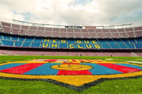soccer field   words visit camp nou stadium barcelona written  yellow  blue