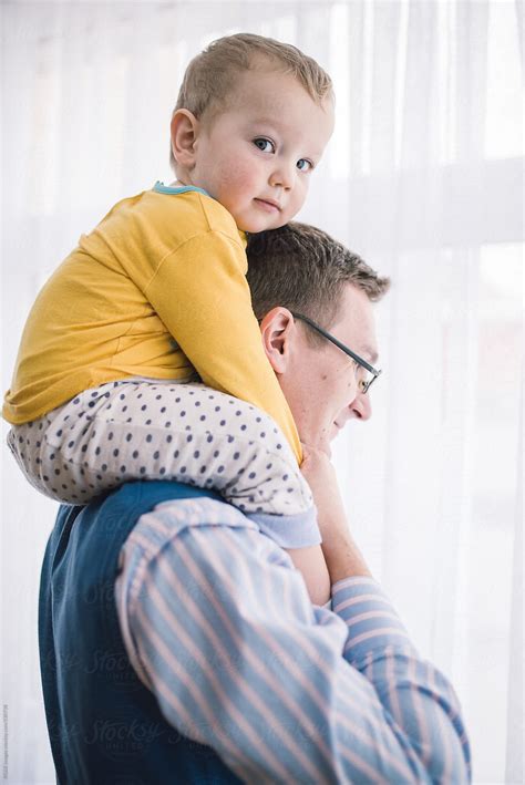 young father holding baby  shoulders  stocksy contributor ibex