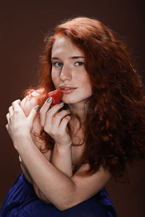 Seductive Redhead Woman In Beige Clothes Holding Fresh Green Apple