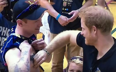 what was prince harry doing to this athlete at the invictus games watch